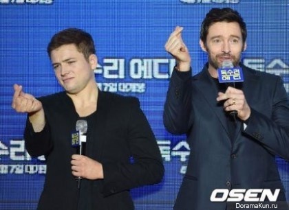 Taron Egerton and Hugh Jackman