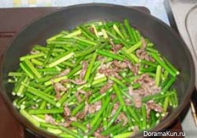 Shoots of garlic with meat